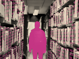 A magenta silhouette of a person walking down an aisle of library stacks, each glowing with binary digits.